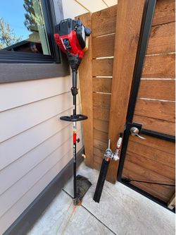 Troy-Bilt 4 stroke string trimmer with hedge trimmer attachment