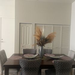 Dining table and chairs sit six