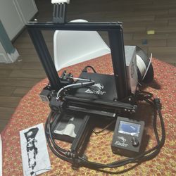 3D printer with half roll of plastic wire.