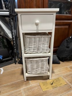 Pair of white bedside tables with wicker baskets