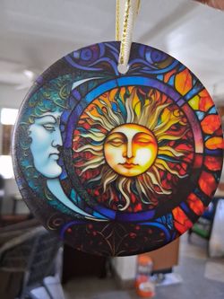 Blue face moon and sun  glass ornament.
