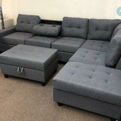 New Dark Grey Reversible Sectional And Ottoman 