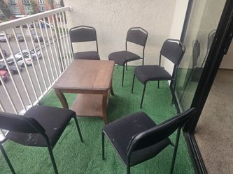 Balcony chair with wooden table.