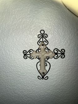 White ceramic cross on black wire frame