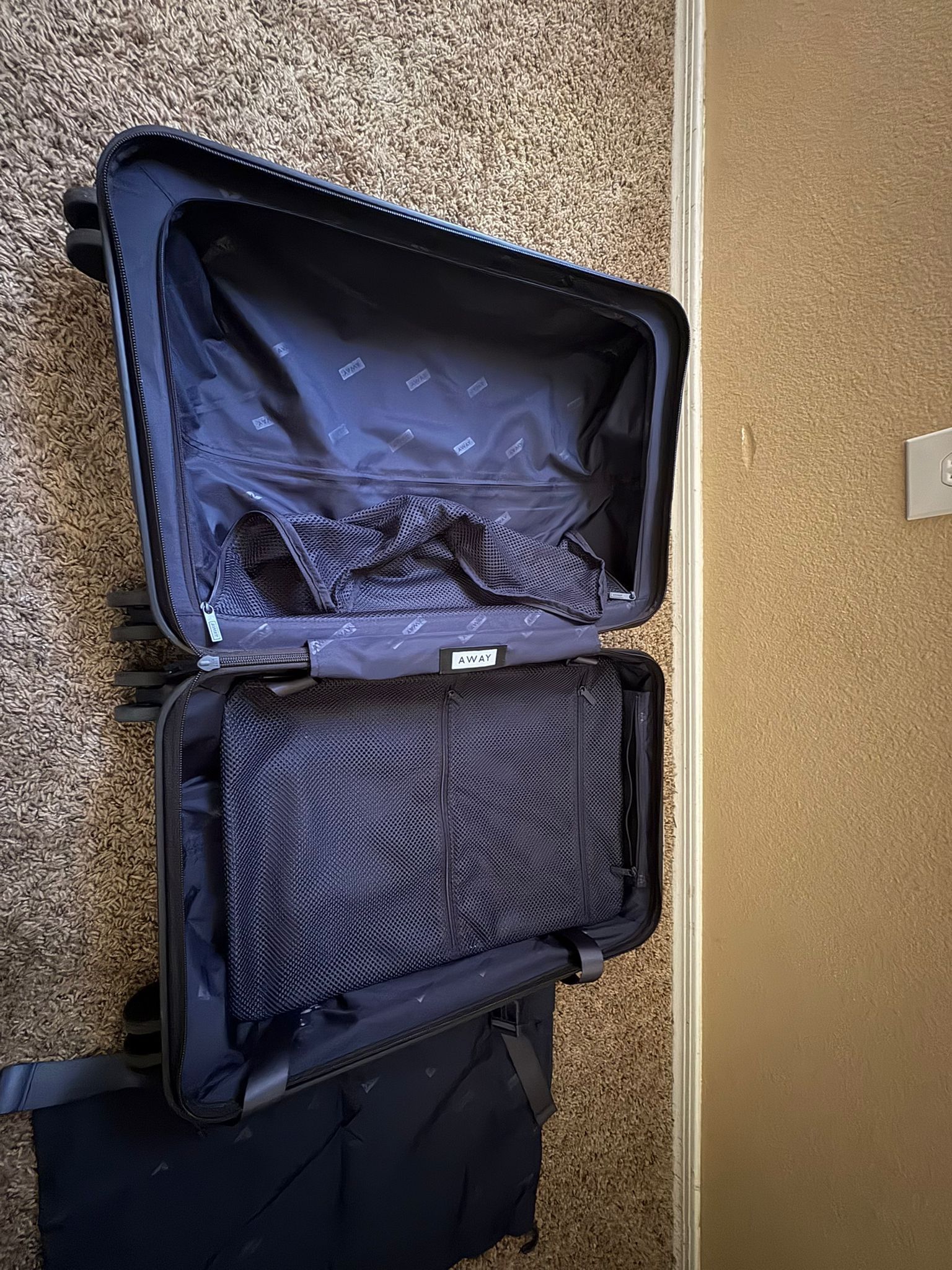 Brand new black hard shelled away carry on size suitcase.