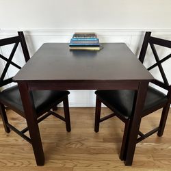 Small Brown Dining Table with Two Cushioned Chairs