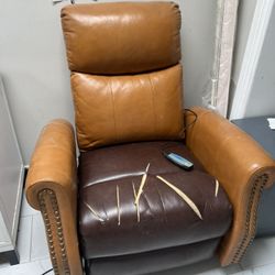 This tan and brown leather power recliner features a wired remote control for massage and heat functions