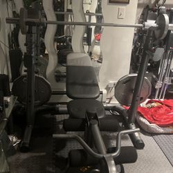 Total Work Out Bench Press W Separate  Squatting Rack  W 4- 45lbs Plates, 1 -25 lbs and 2-10 Lbs Plus the bar