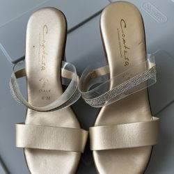 Two pairs of golden sandals