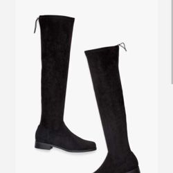 A high flat boot with zip closure.