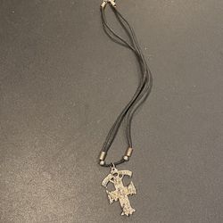 Vintage "Guns N Roses" Charm on cord. Metal charm measures approximately 1.75" x 1.25".