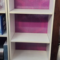 2 White Book Shelves With Purple Background