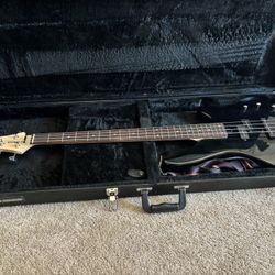 Black Yamaha Bass with hard case and strap.