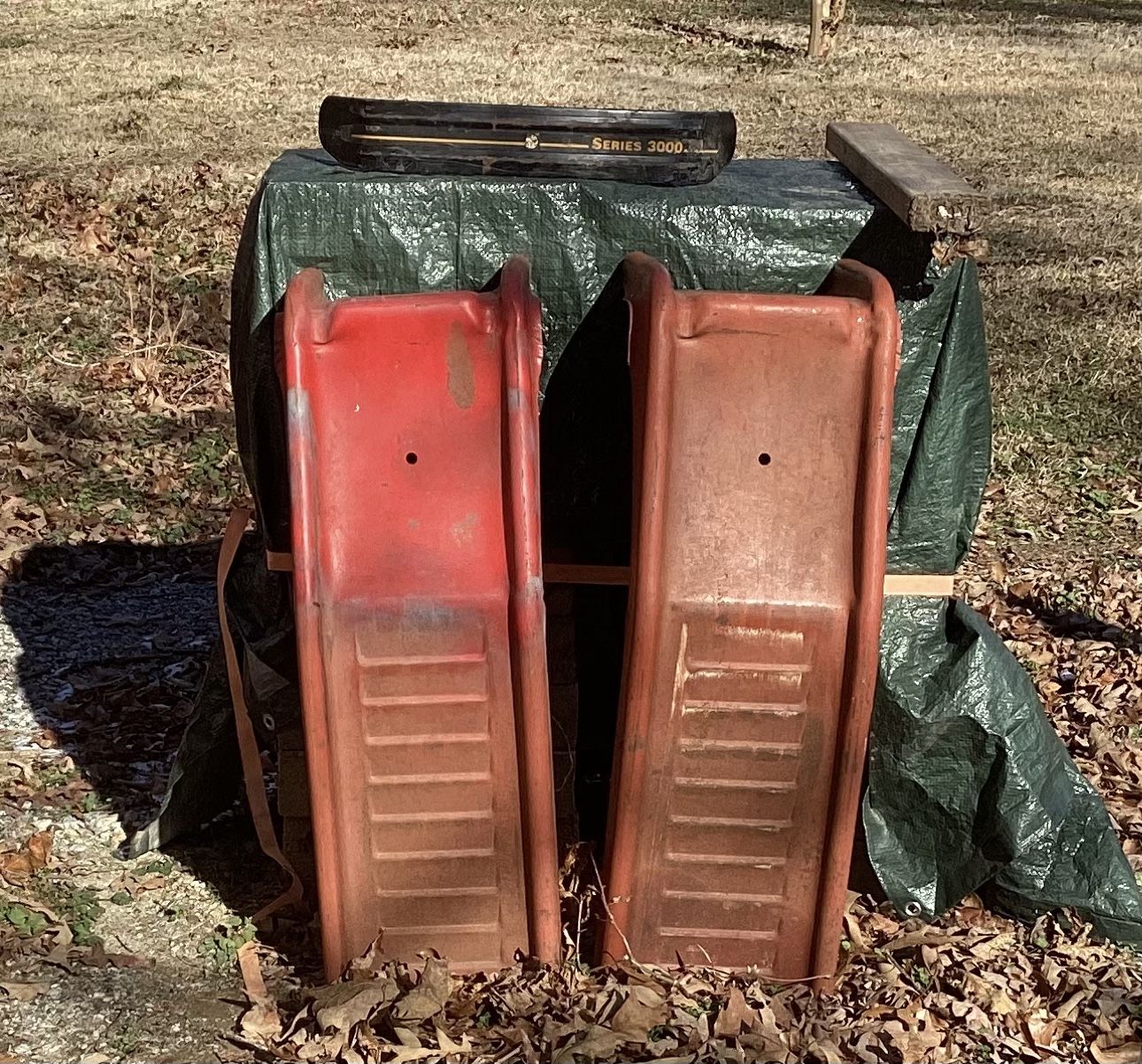 Two matching metal car ramps.
