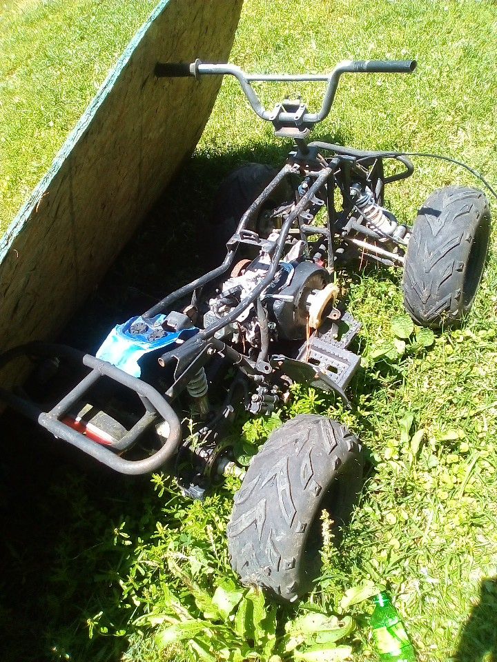 It's A Four Wheeler Don't Know The Model It's Black And It's A 125 Cc