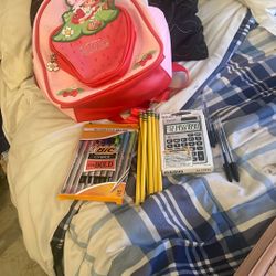 Strawberry shortcake, backpack, number two pencils colored pens, few black pens, calculator, and paper