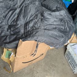 A round circle pillow with two small ones on the side color dark gray it’s probably a medium for a lucky bumble chair