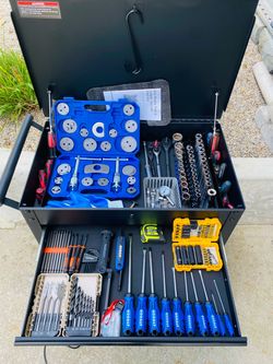 A highly organized, fully loaded mobile mechanical tool cart featuring a built-in top chest compartment, sliding drawers, and a lower bulk storage she