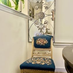 Antique  embroidered accent chair on coasters . 