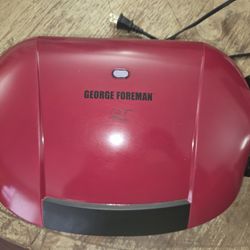 The George Foreman GRP0004R is a red, 5-serving electric indoor grill and panini press