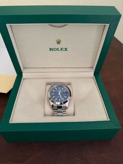 Beautiful luxury-style watch featuring a blue textured dial, fluted-style bezel, date window with magnification, and a stainless-steel Jubilee-style b