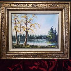 Vintage framed oil painting on canvas depicting a serene lakeside landscape scene. 21.5"×20"