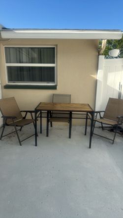Table with 3 chairs included for outside