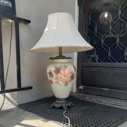 This elegant 1930s-1940s lamp stands 33 inches tall and features a hand-painted porcelain vase base with vintage floral designs. Its 20-inch diameter 