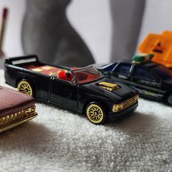 (4)- Toy Vehicles including a '59 Chevy Impala, '90s Chevy S10 Pickup Truck, Chevrolet Chevy Caprice and an orange Dump Truck. 1:64 Scale