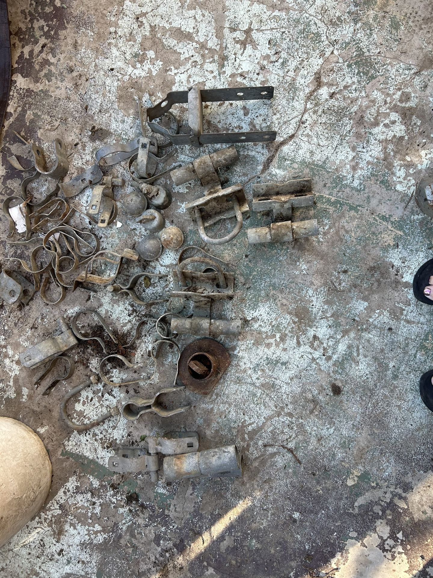 These are various metal fence fittings and hardware, likely for chain-link fencing.
