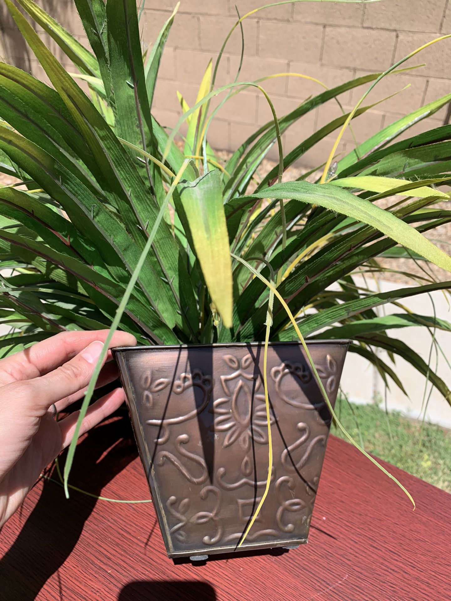 Fake plant in metal pot