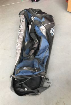 baseball bag and three helmets