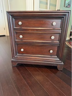 Dark brown side table with drawers