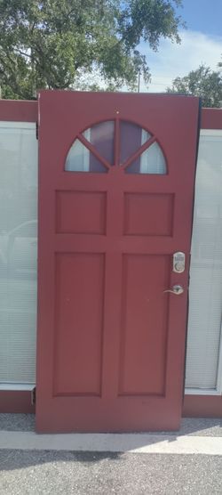Exterior solid wood single door with top light half Moon approximately 35.75x79.5 good condition