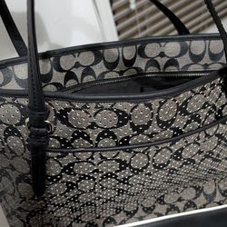 Coach Peyton Perforated PVC Zip Top ToteThe interior typically includes a zip pocket, a cell phone pocket, and multifunction slip pockets. There is of