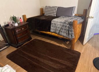 Log pole honey oak stained twin day bed with metal trundle