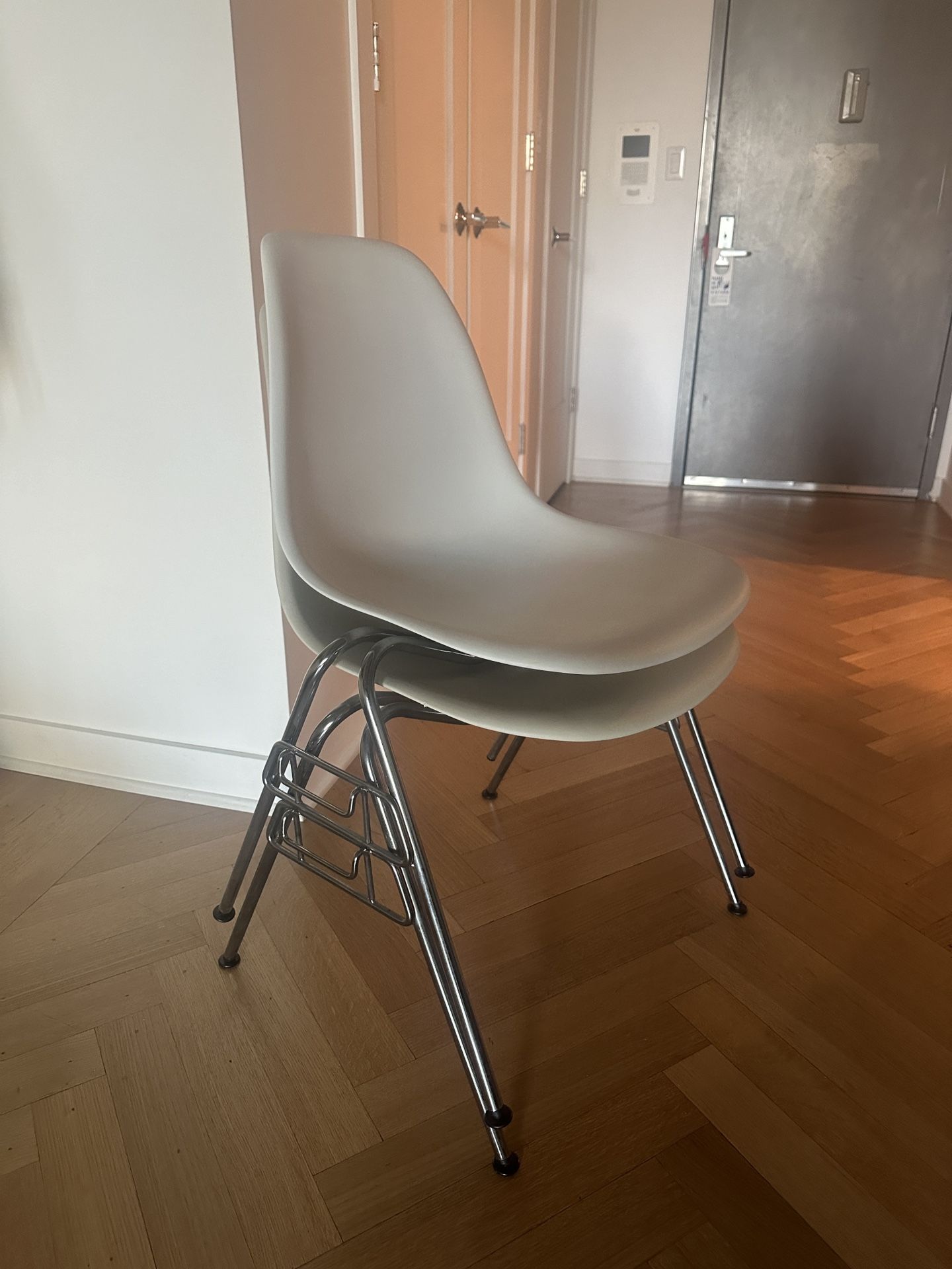 Two Eames Molded Plastic Stacking Chairs From DWR