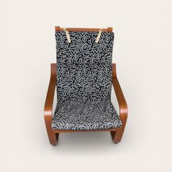 IKEA POÄNG armchair with a bentwood frame and a black and white patterned cushion. 