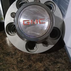 Metal GMC wheel center caps.