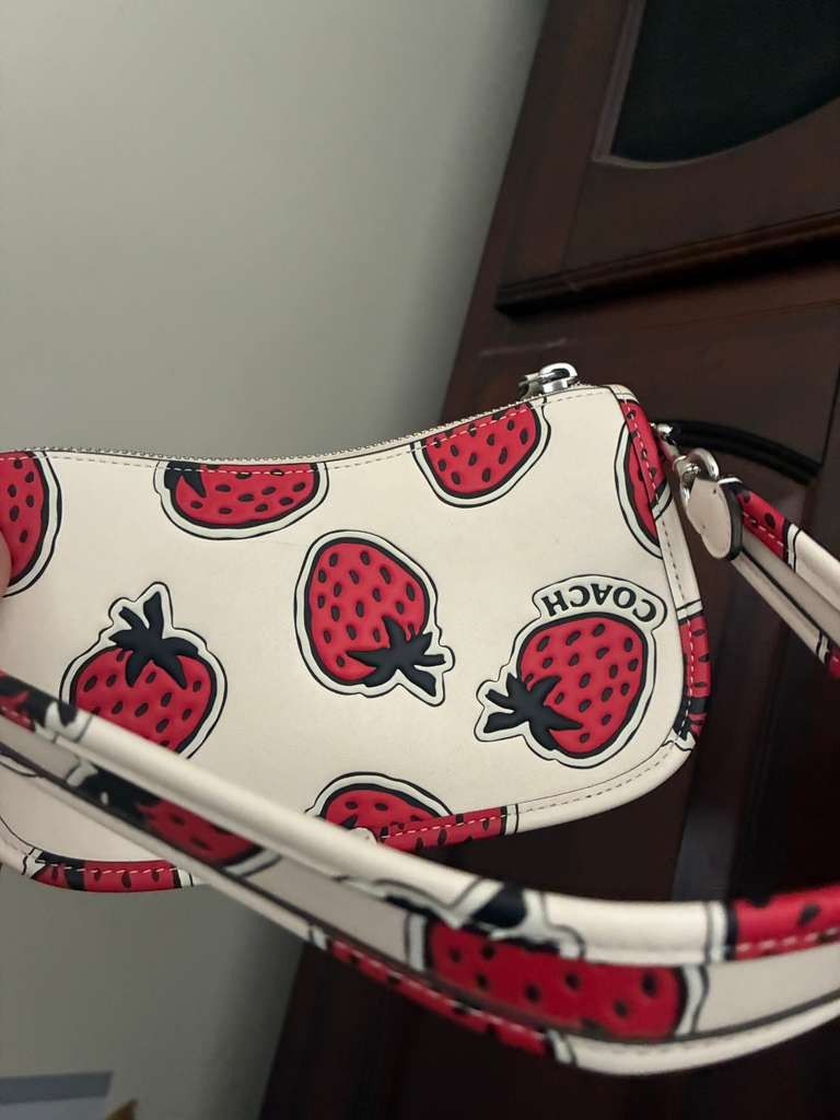 Coach Swinger 20 bag with a strawberry print