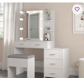 white vanity with lights and  stool