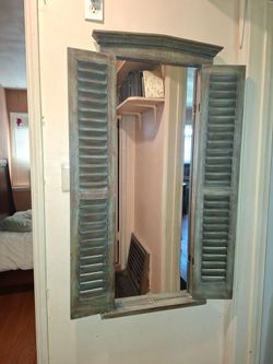 Wall mirror with shutters