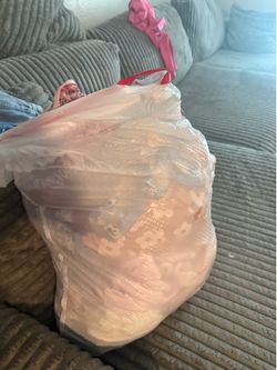 Bag of baby girl clothes read below