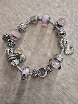 Authentic Pandora sterling silver bracelet and charms.