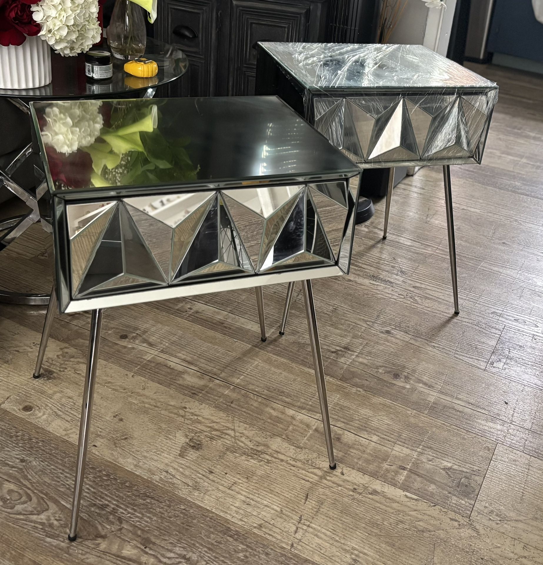 Modern mirrored side table with geometric design.