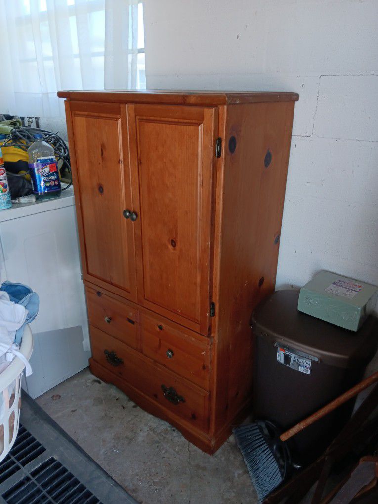 A Brown Wood ARMOIRE, One Metal Shelf, and a Metal Work Bench.