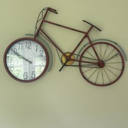 Fun bicycle wall clock for sale! Unique design with a clock in the front wheel. Great condition, perfect for adding character to any room.