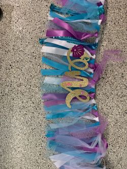 Purple and blue “ONE” high chair sign