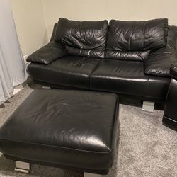 Black Leather Love Seat And Ottoman.