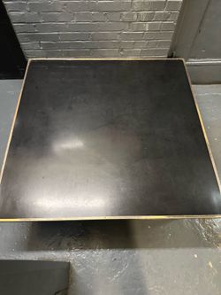 Black laminate square table with brass/gold trim